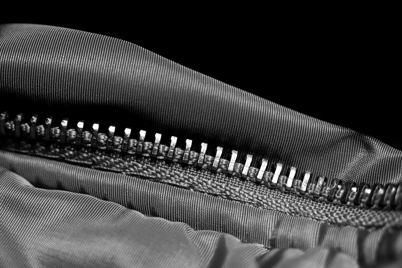 Pose d’une fermeture éclair métallique avec rubans bien plaqués et butées visibles, couture rectiligne.