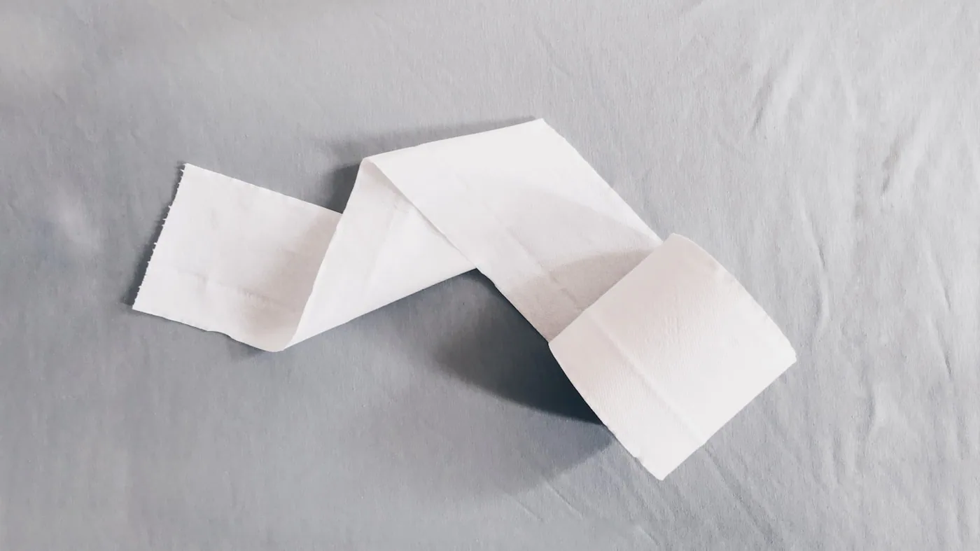T‑shirts pliés proprement, enveloppés de papier de soie avec un sticker minimaliste.