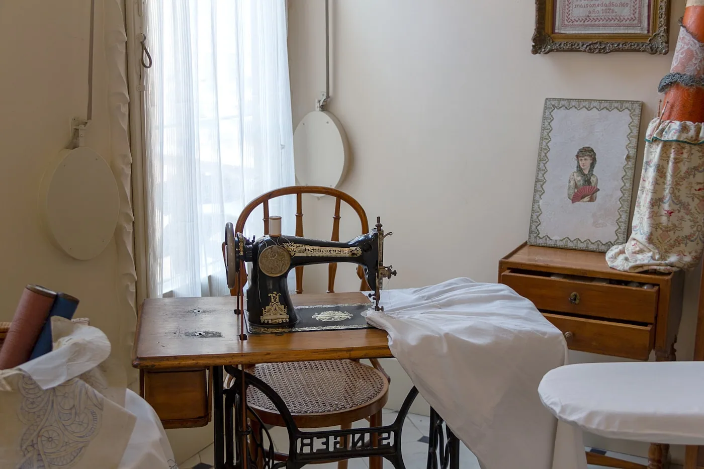 Salle d’échantillonnage avec toiles, prototypes sur mannequins et machines dédiées.